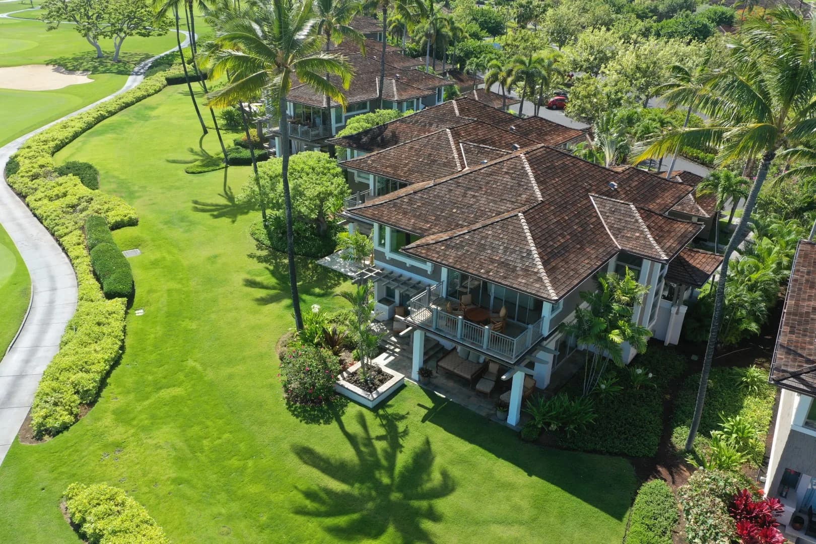 Drone view of a residence beside a golf course on Hawaiʻi Island